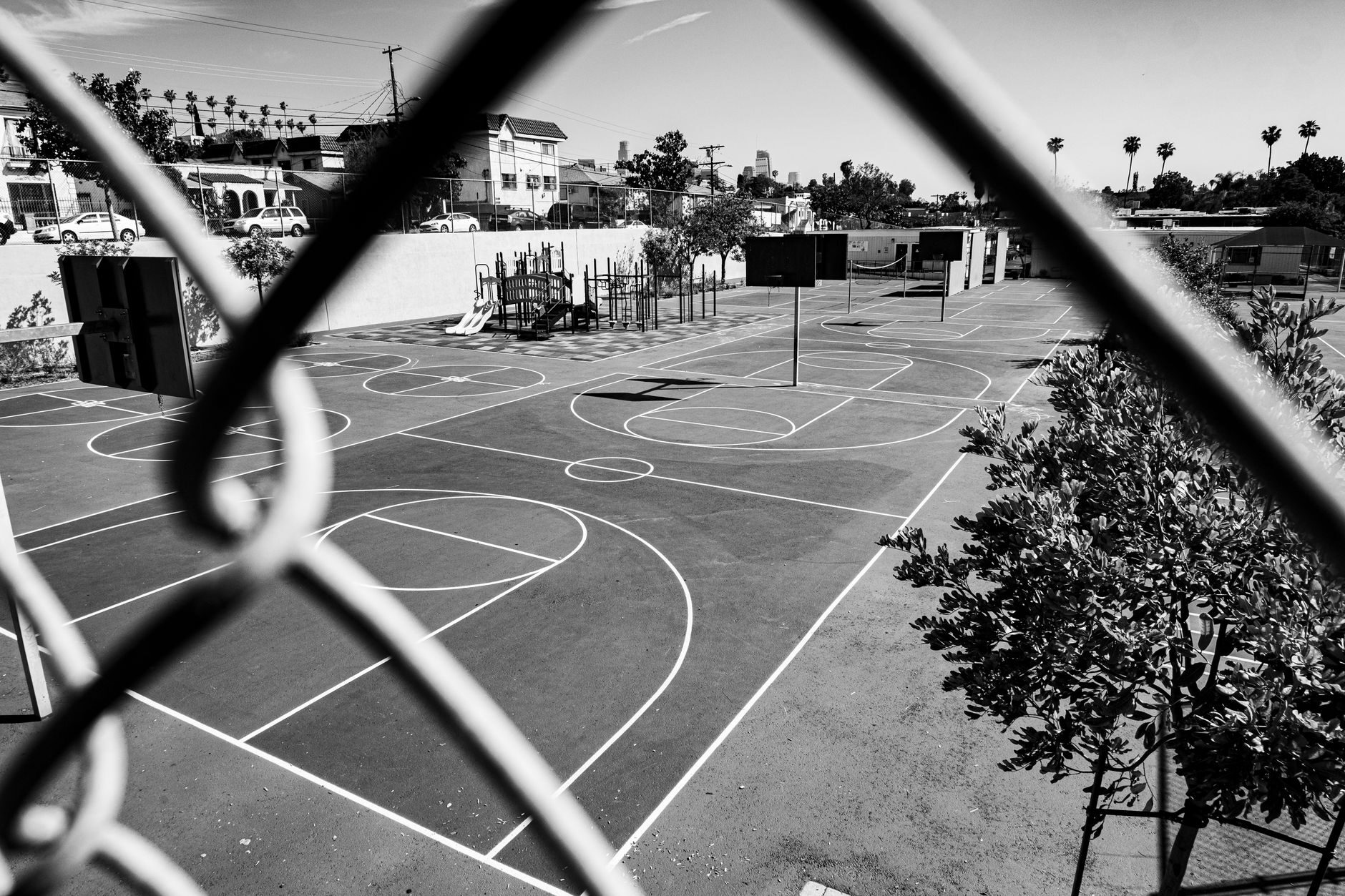 Outdoor concrete basketball court with a hoop