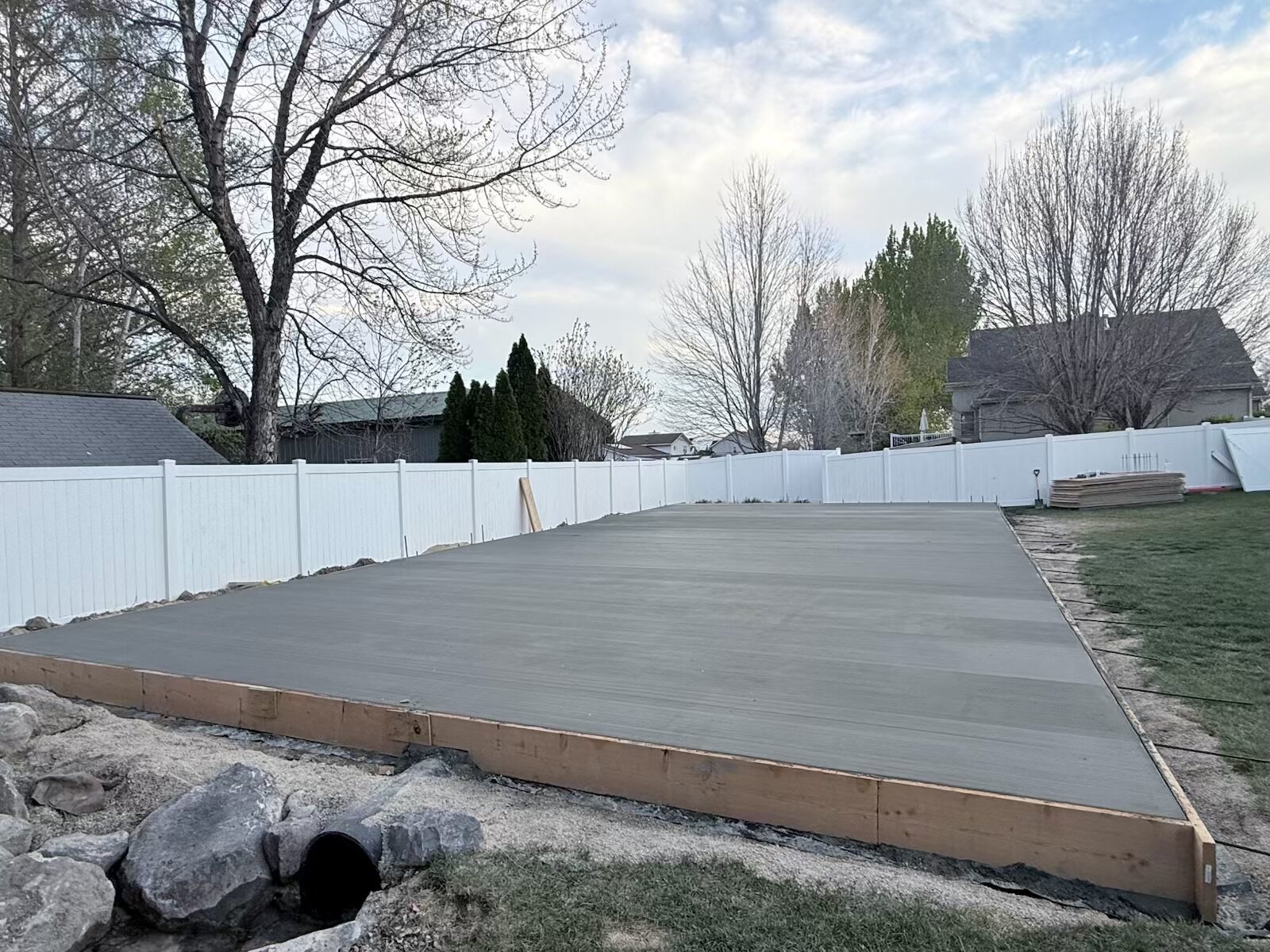 Large concrete patio in a fenced Utah backyard